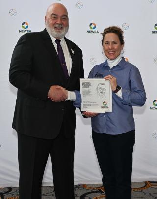 Engineer-Director/Treasurer Karla Sangrey accepting the Alfred E. Peloquin Award