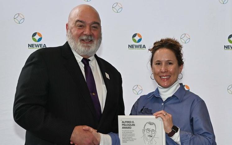 Engineer-Director/Treasurer Karla Sangrey accepting the Alfred E. Peloquin Award